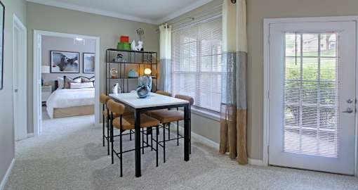 Spacious dining room with lots of natural light, huge windows, French door, and 9-foot ceilings at Breckenridge Apartments in Omaha, Nebraska