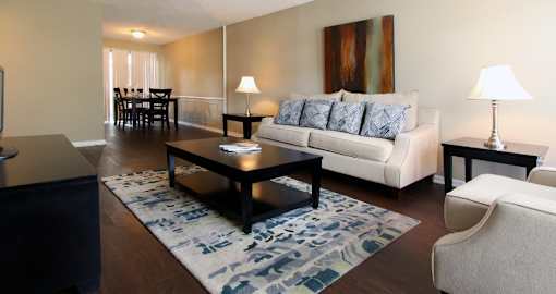 A living room with a white couch and a coffee table.