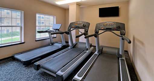 Cardio room with treadmills and TV at the clubhouse at Breckenridge Apartments in Omaha, NE