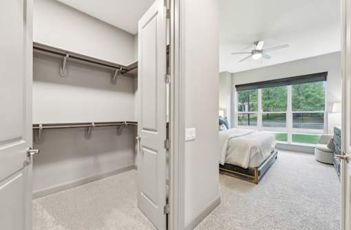 Huge walk-in closet and spacious master bedroom with scenic views at Xenia Apartments in Golden Valley Minnesota