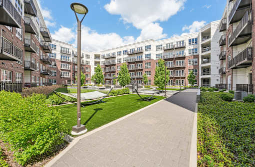 Luxury apartments with huge courtyard with lush landscaping, green space and hammocks at Xenia Apartments in Golden Valley Minnesota
