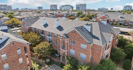 Gated luxury apartment community in north Dallas with red brick exteriors at The Saxony Apartments