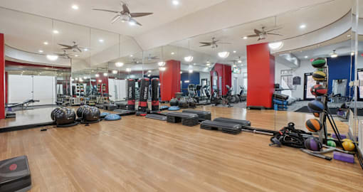 Huge spacious fitness center with variety of cardio and weight-lifting equipment at Saxony Apartments in Dallas