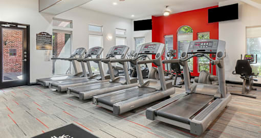 Huge spacious fitness center with variety of cardio and weight-lifting equipment at Saxony Apartments in Dallas