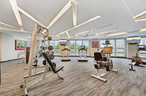 Huge fitness center, spacious fitness center with cardio machines, workout equipment and weights at Xenia Apartments in Golden Valley Minnesota