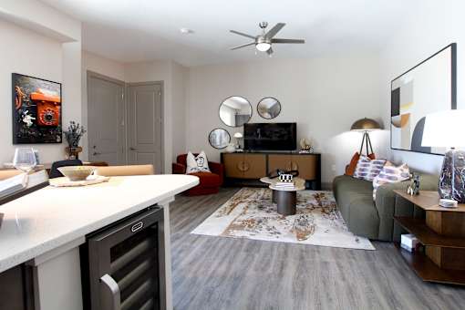 A modern kitchen with a dining area and a living room.