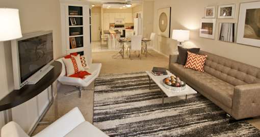 Spacious apartment in central Omaha with condo-style layout, white kitchen cabinets, kitchen island, and built-in shelves at Embassy Park Apartments