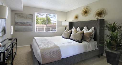 Spacious bedroom with walk-in closet and gray wall color at The Inverness Apartments in La Vista, Nebraska