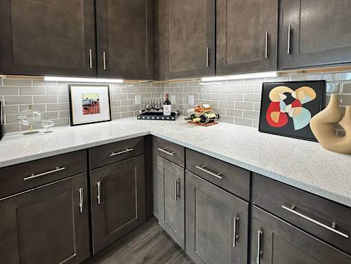 A kitchen with brown cabinets and a white countertop.
