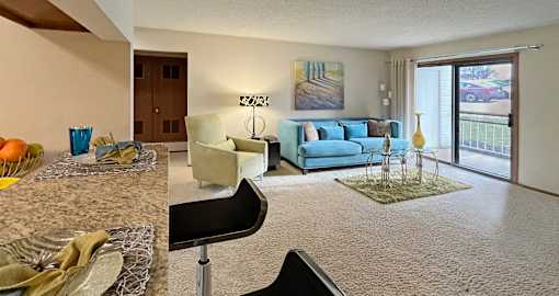 Spacious living room with granite breakfast bar at LionsHead Apartments in Omaha Nebraska