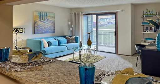 Spacious living room with granite breakfast bar at LionsHead Apartments in Omaha Nebraska