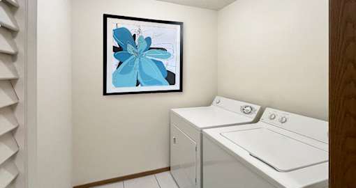 Spacious laundry room with full-sized washer and dryer at LionsHead Apartments in Omaha Nebraska