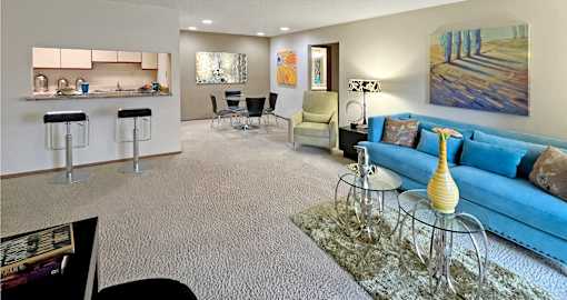 Spacious living and dining room area with granite breakfast bar, and painted feature wall at LionsHead Apartments in Omaha Nebraska