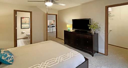 Spacious bedroom with walk-in closet and attached bathroom at LionsHead Apartments in Omaha Nebraska