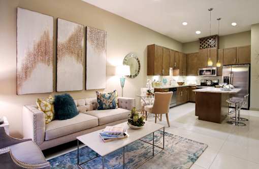 Luxury apartments with spacious open floor plan with built-in wine rack, granite countertops, kitchen island, stainless steel appliances, and designer tile backsplash at Tuscany Walk Apartments in Houston Texas.