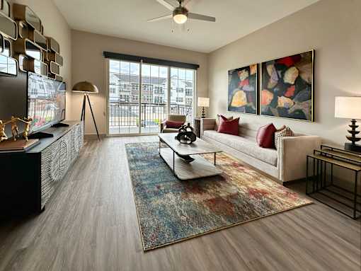 A living room with a couch, a coffee table, and a painting on the wall.
