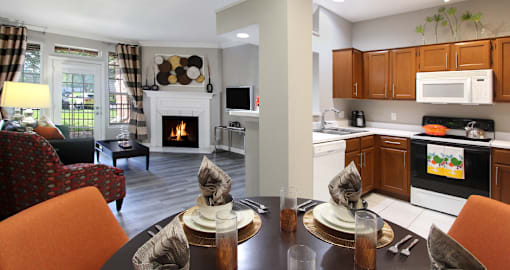 Luxury apartments with wood grain plank floors, dining room, u-shaped kitchen, 9-foot ceilings, and woodburning fireplace at Lenox Village Apartments in Lincoln, Nebraska