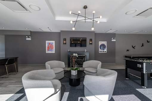A room with grey walls and a pool table.