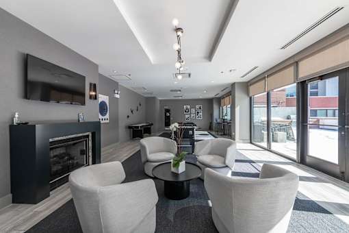A modern living room with a fireplace and a flat screen TV.