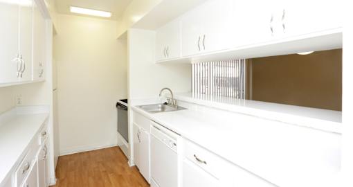 Apartments near the Galleria with bright white kitchens, wood plank floors, and extra cabinet space