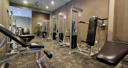 Luxury apartments with a fitness center in a gated community at Preston Village Apartments in North Dallas