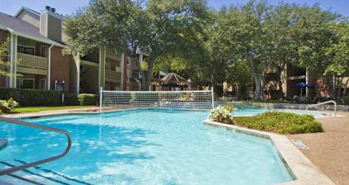 Luxury apartments with beautiful fountains, beautiful landscaping, gazebo, spa, and swimming pool with poolside lounge chairs, grilling station and scenic views at Preston Village Apartments in north Dallas