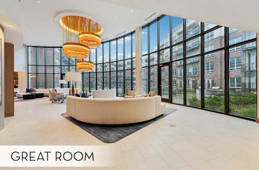 Luxury resident lounge wi-fi common space, luxury seating area with huge windows and chandeliers at Xenia Apartments