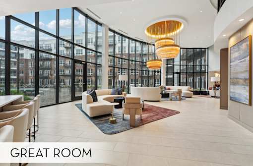 Luxury resident lounge wi-fi common space, luxury seating area with huge windows and chandeliers at Xenia Apartments