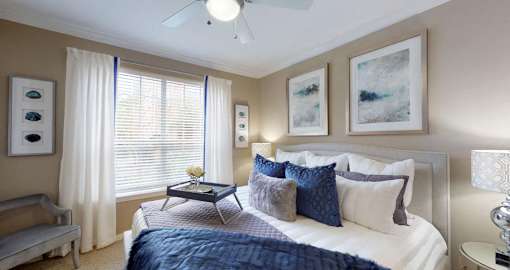 Luxury apartments with spacious bedrooms, walk-in closets, and ceiling fans at Tuscany Gate Apartments in Houston.