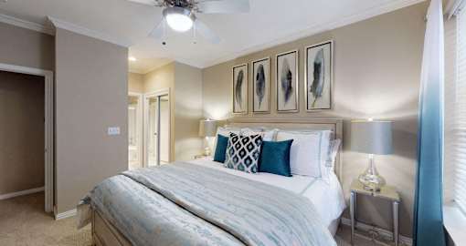 Luxury apartments with spacious bedrooms, walk-in closets, and ceiling fans at Tuscany Gate Apartments in Houston.