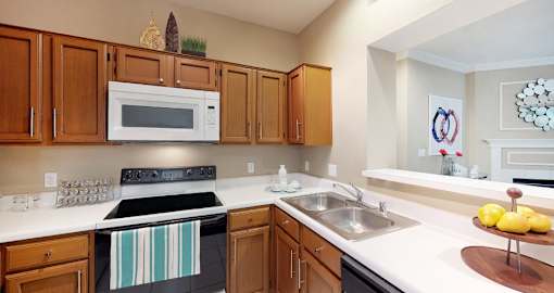 Luxury apartments with spacious kitchens, custom home cabinets, and breakfast bars at Tuscany Gate Apartments in Houston.