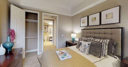 Spacious master bedroom with attached walk-in closet and master bathroom at RidgeGate Apartments in Minnetonka, Minnesota