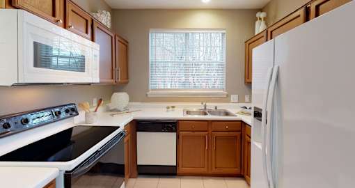 Luxury apartments with spacious kitchens, custom home cabinets, and side-by-side refrigerators at Tuscany Gate Apartments in Houston.