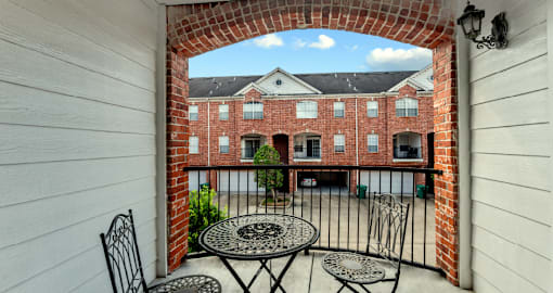 Luxury townhomes in a gated community with red brick exteriors and attached 2-car garages at Tuscany Row Townhomes in Houston.
