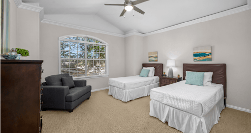 Huge bedroom, spacious bedroom with vaulted ceiling, ceiling fan, walk-in closet, and attached bathroom at Tuscany Row Townhomes in Houston.