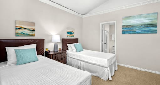 Huge bedroom, spacious bedroom with vaulted ceiling, ceiling fan, walk-in closet, and attached bathroom at Tuscany Villas in Houston.
