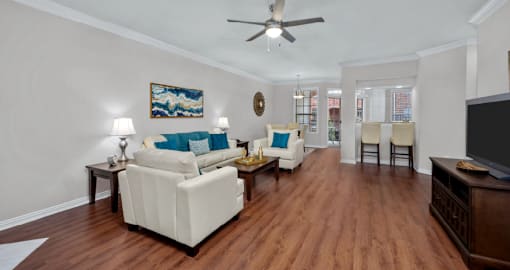 Spacious living room, huge living room with wood-burning fireplace, hardwood floors, crown molding, breakfast bar, spacious dining room, and 9-foot ceilings, at Tuscany Villas in Houston.