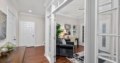 Huge office space, spacious den with built-in shelves, hardwood floors, and private backyard patios at Tuscany Villas in Houston.