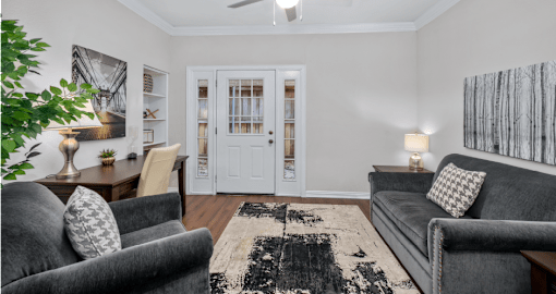 Huge office space, spacious den with built-in shelves, hardwood floors, and private backyard patios at Tuscany Villas in Houston.