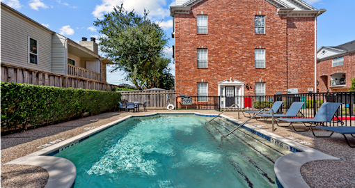Luxury townhomes with swimming pool and poolside lounge seating at Tuscany Row in Houston.