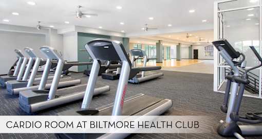 A cardio room at Biltmore Health Club with treadmills and elliptical machines.