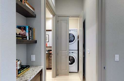 Luxury apartments with stacked font loading washer and dryer at Le Palais Apartments in Houston.