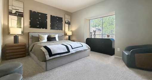 A bedroom with a large bed and a window.