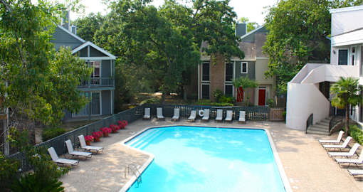 Gated apartments with 4 swimming pools, convenient bayou location, lush landscaping and scenic views at Woodlake on the Bayou Apartments in Houston.