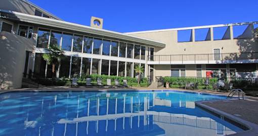 Gated apartments with 4 swimming pools, convenient bayou location, lush landscaping and scenic views at Woodlake on the Bayou Apartments in Houston.