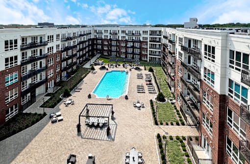 Aerial view of courtyard and resort-style pool with cabanas and lounge chairs at Xenia Apartments in Golden Valley Minnesota