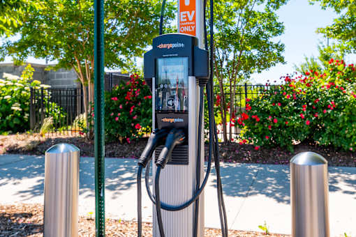 An electric vehicle charging station is located in a park.