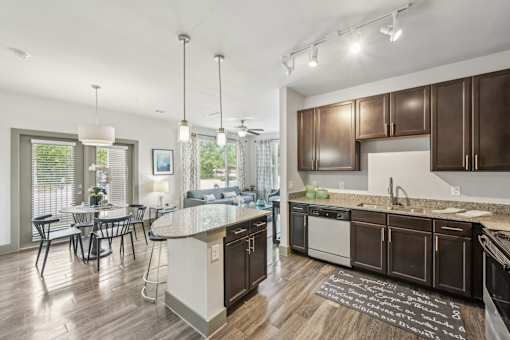 A modern kitchen with dark wood cabinets and a white island.