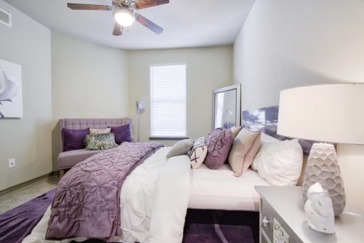 a bedroom with a bed and a ceiling fan