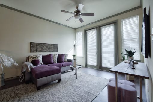 a living room with white walls and a purple couch